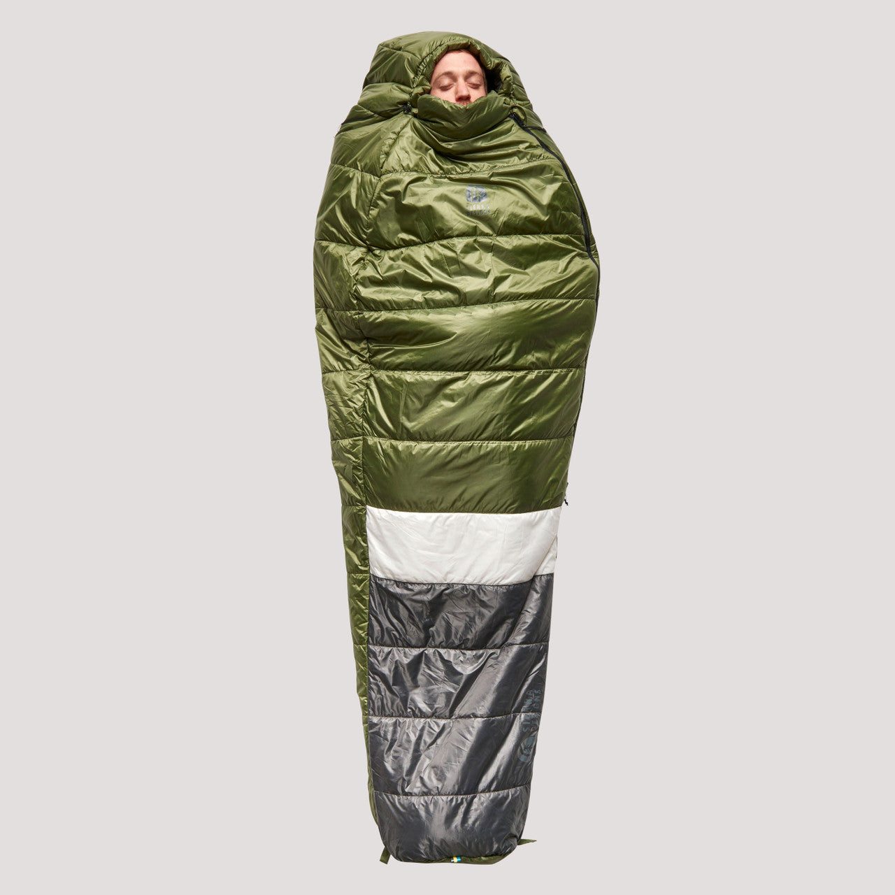 Sierra Designs Shut Eye 20 sleeping bag, green/gray with white stripe, top view, fully closed, with man sleeping on his back
